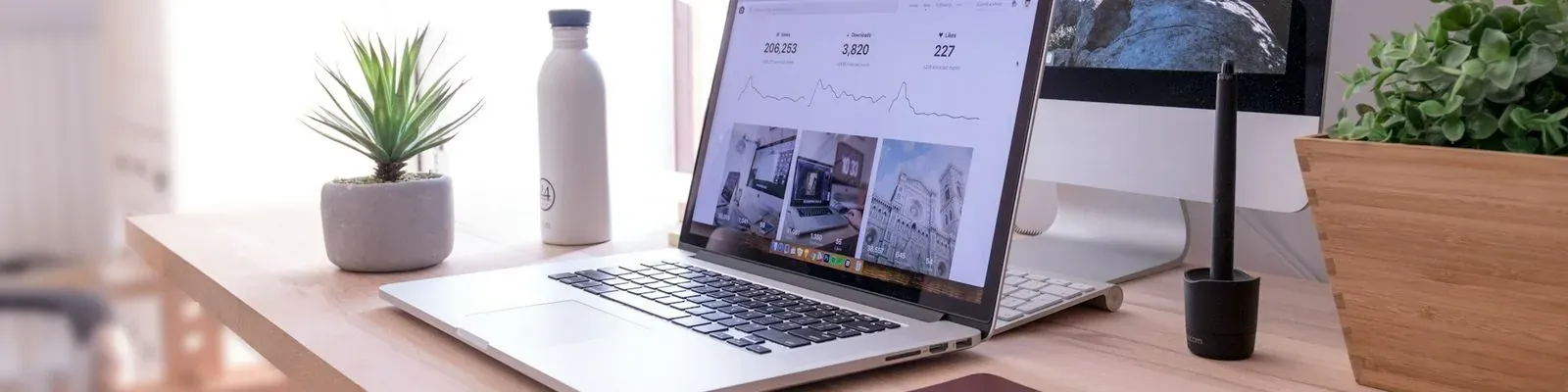 A laptop and a monitor on a wooden desk