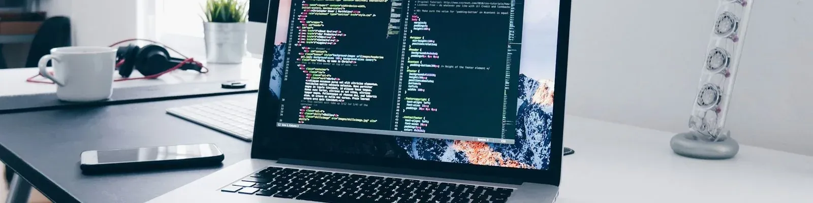 A laptop showing code on a desk